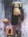 Aldaba en forma de mano sobre una puerta de madera, en la casa rural El Callejo